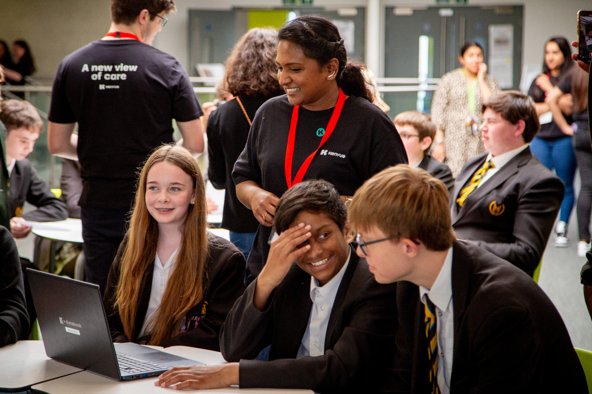 Mentor guiding students through a workshop